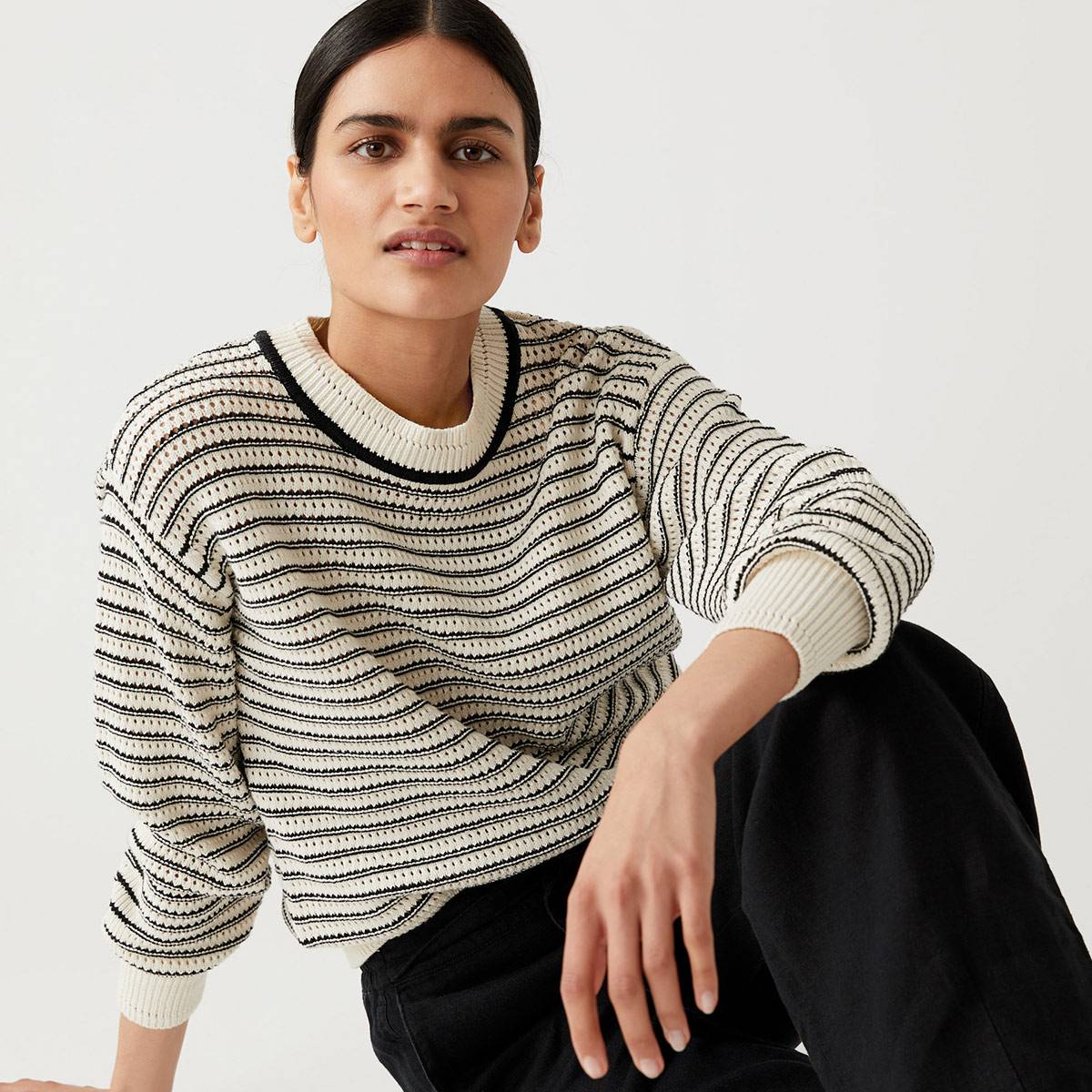  Model wearing black and white striped knit